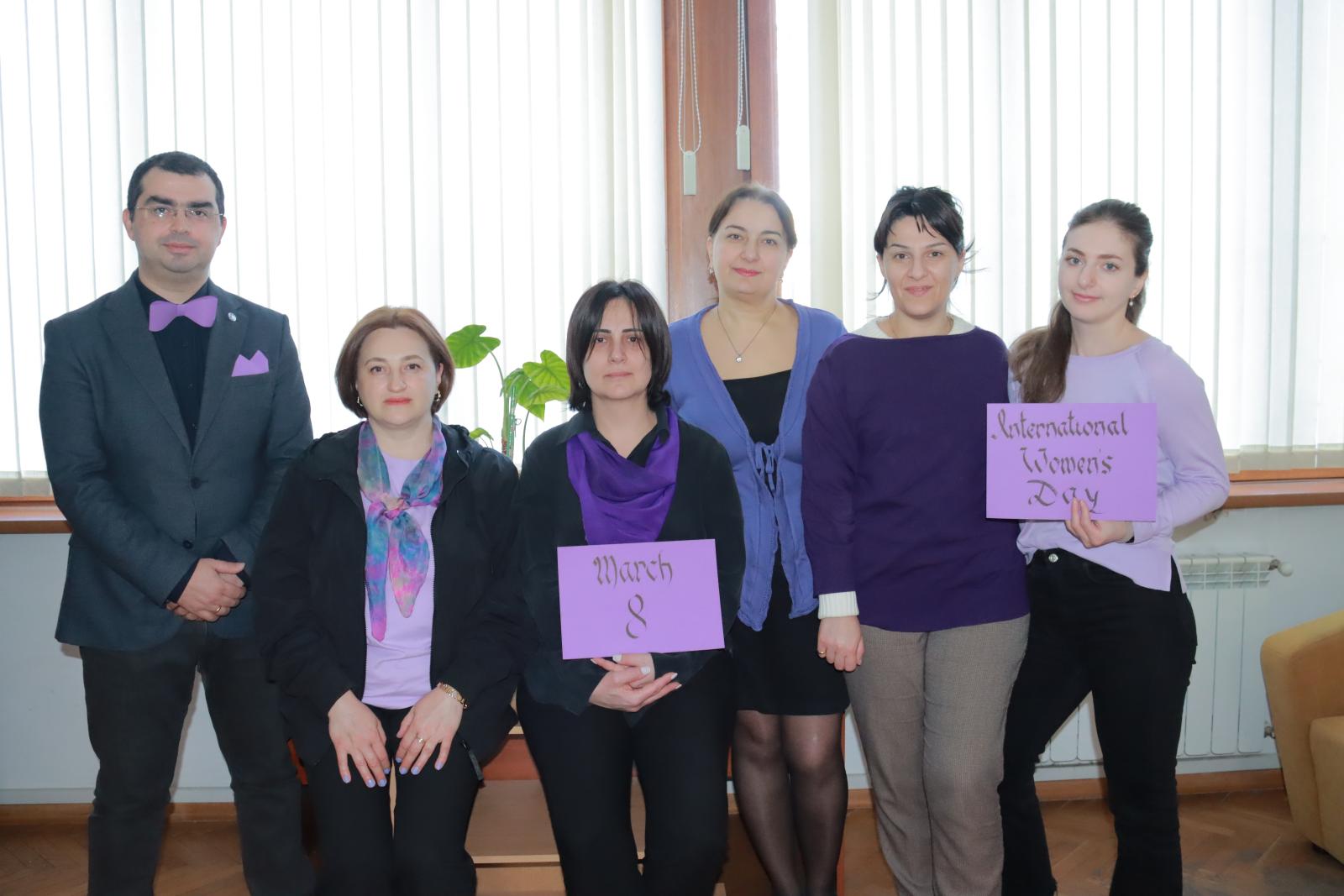 IFES Georgia in purple with purple signs for IWD 2023