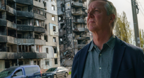 Tony Banbury in front of destroyed buildings in Ukraine